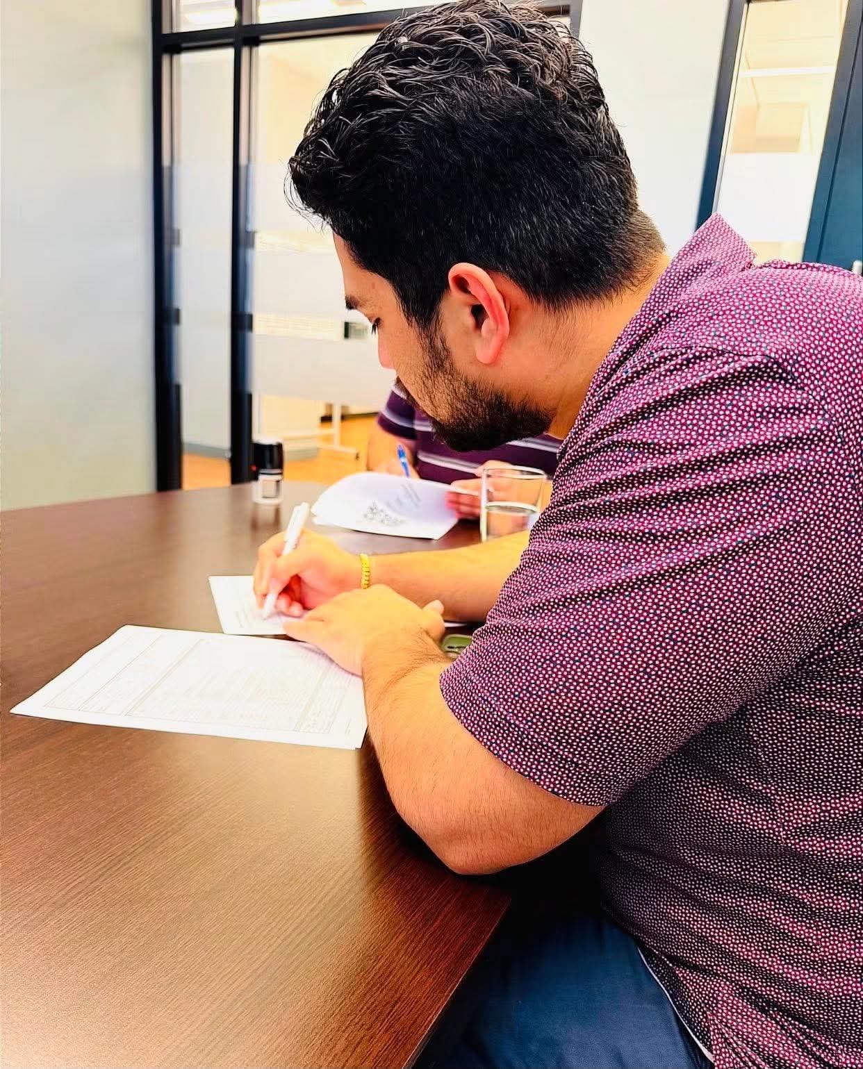 Buyer signing closing paperwork at the closing table
